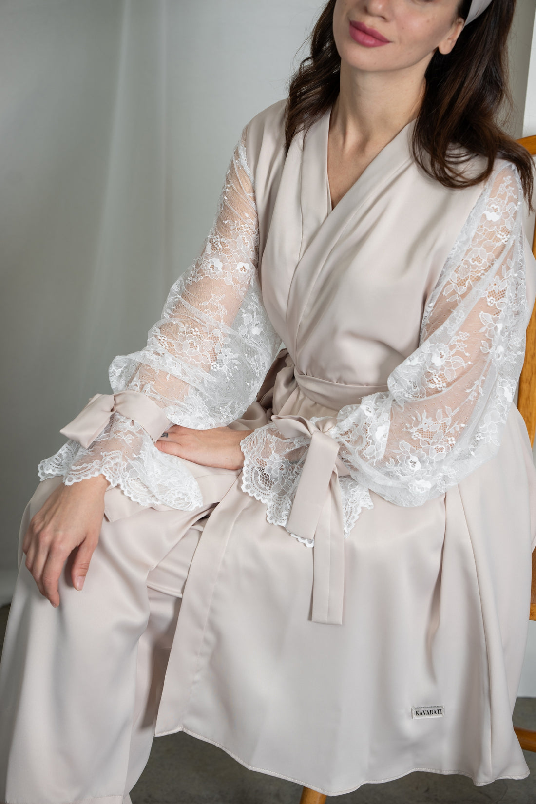 Woman wearing a white robe and pants in a minimalistic setting